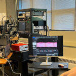 Dr. Scott Hammond and a Keysight employee tests NLM's PICs