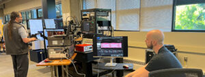 Dr. Scott Hammond and a Keysight employee tests NLM's PICs