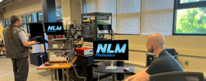 Scott and Keysight employee look at the results from NLM's PICs